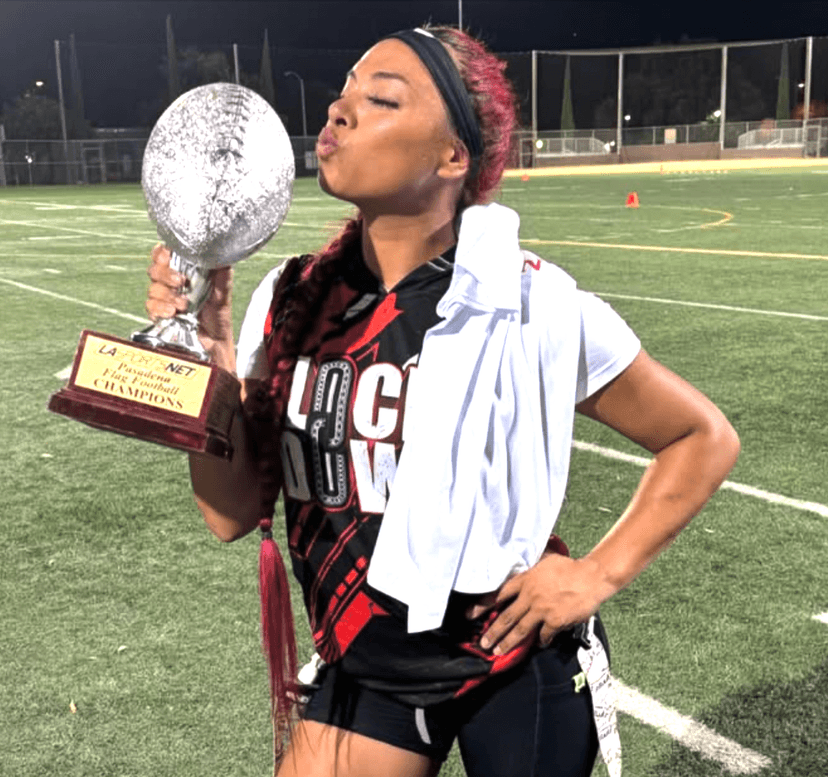 A ref signaling a play on a flag football field